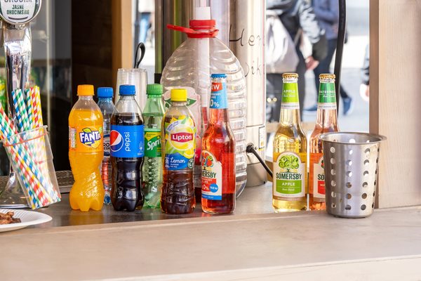An assortment of beverages from recognizable brands, including Fanta, Pepsi, Sprite, and Lipton.